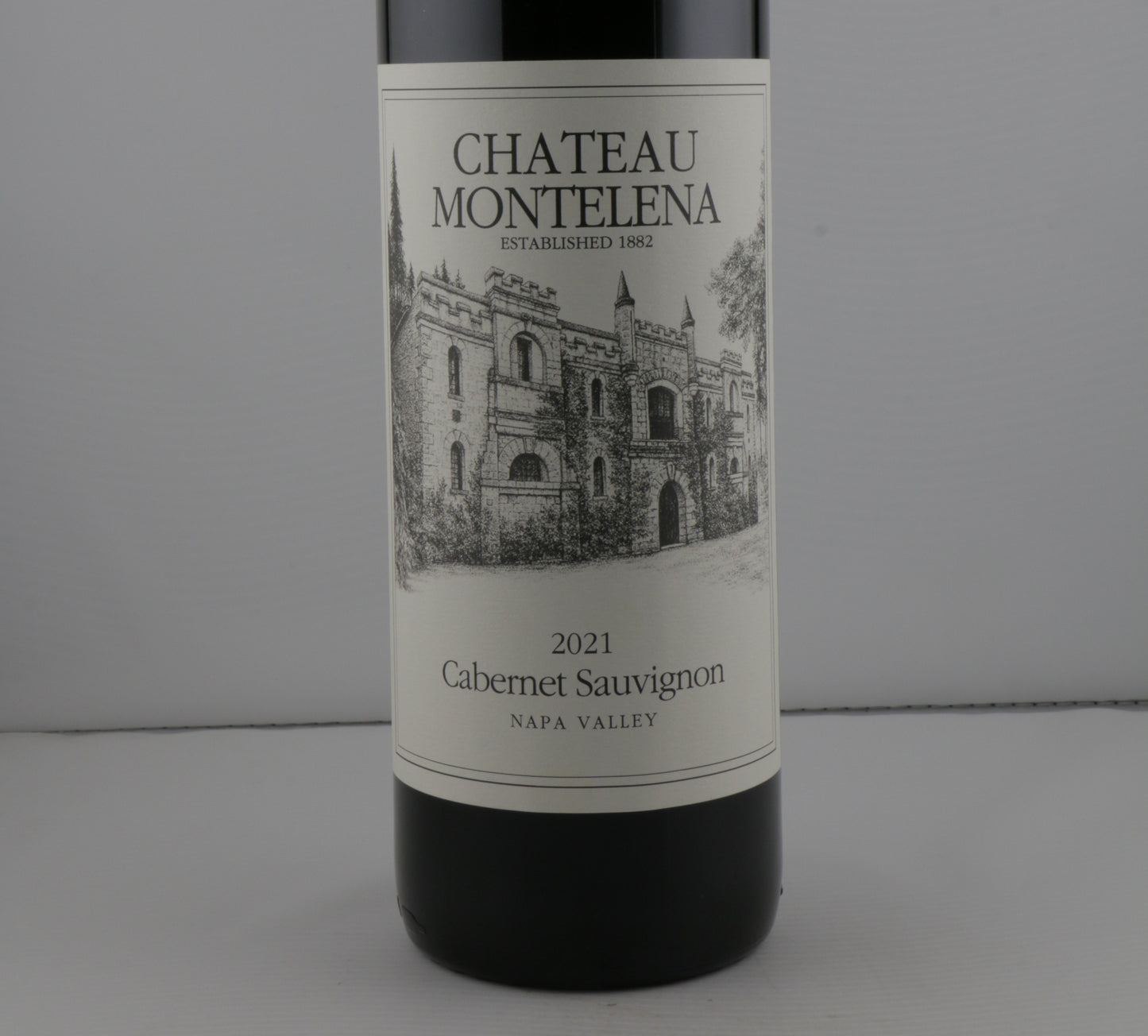 Chateau Montelena wine bottle with zoom in view of the label on a gray background