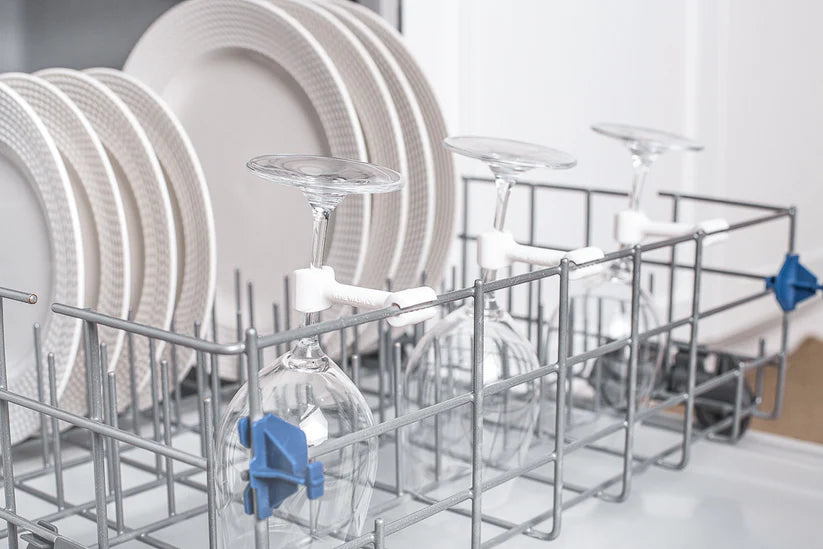 Dishwasher with clean dishes including plates, glasses, and bowls.