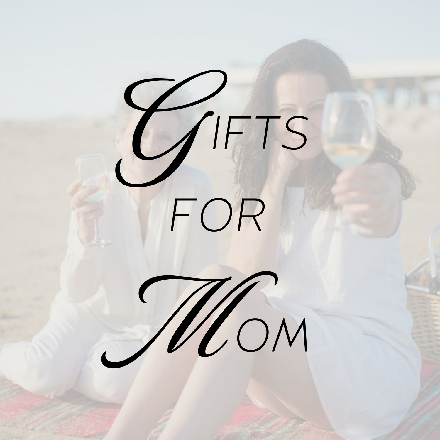 Mom and grandma share a glass of wine on the beach for Mother's Day