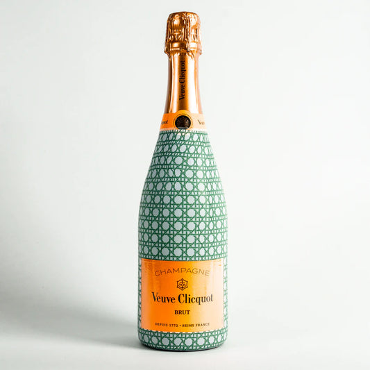Wrap A Bottle of Veuve Clicquot champagne bottle decorative green and white patterned cover on a light gray background