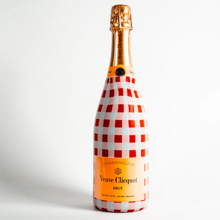 Veuve Clicquot champagne bottle with red and white checkered design on a white background