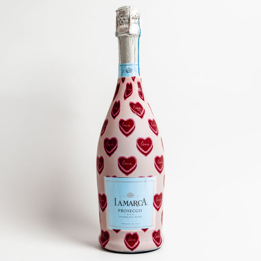 Bottle of Lamarca Prosecco with red heart pattern on a white background