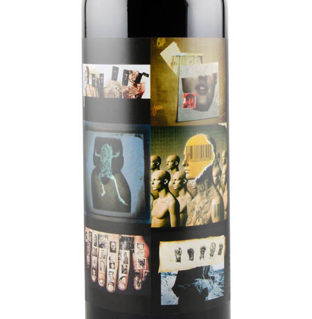 Wine bottle with a unique label featuring artistic designs on a white background